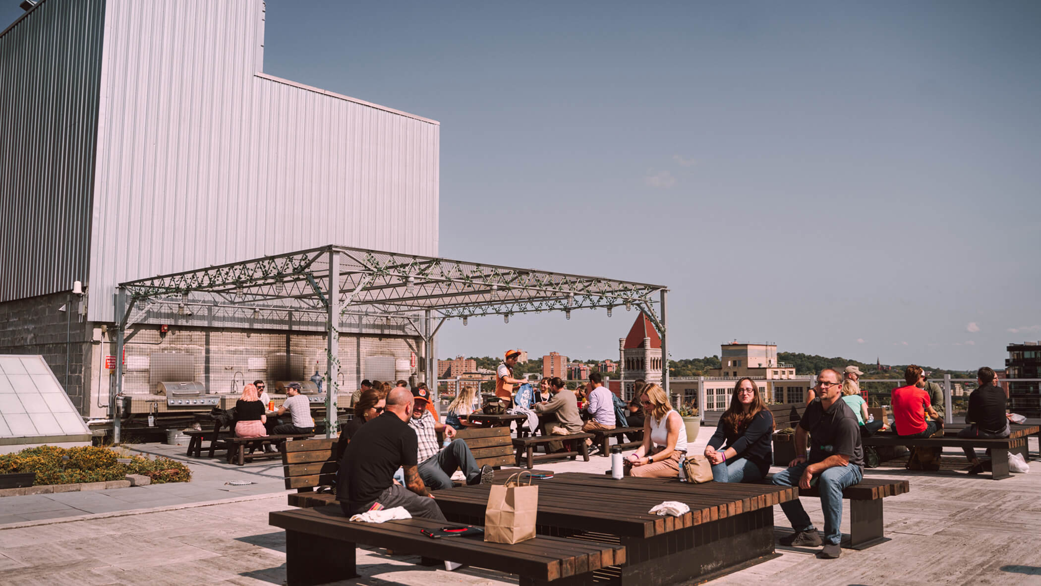 attendees sitting on a rooftop patio
