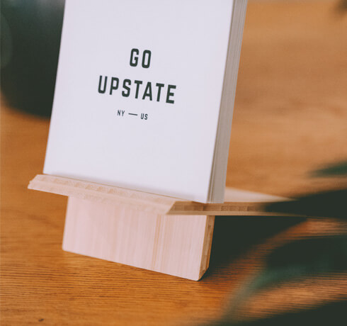 a close-up of a card that says "go upstate"