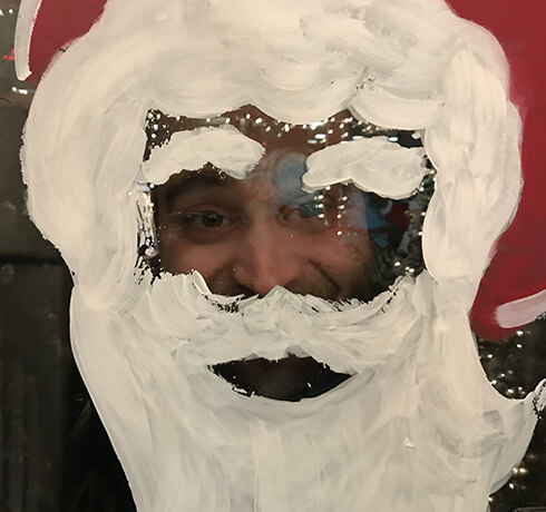 Dan looking through a santa claus face