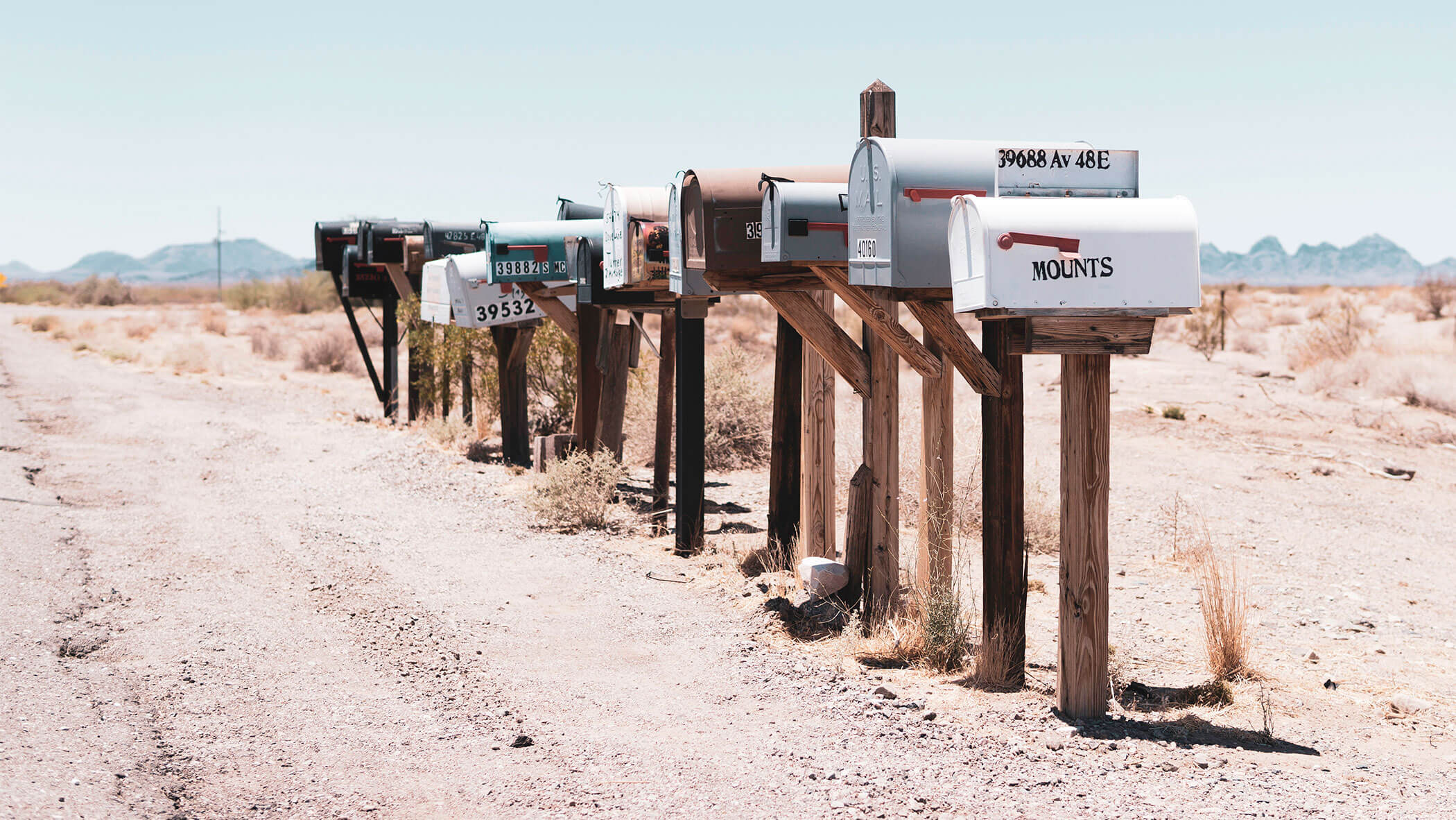 a collection of mailboxes alongside a road