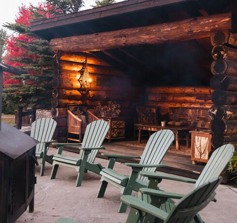 Adirondack chairs at Whiteface Lodge with leanto in background